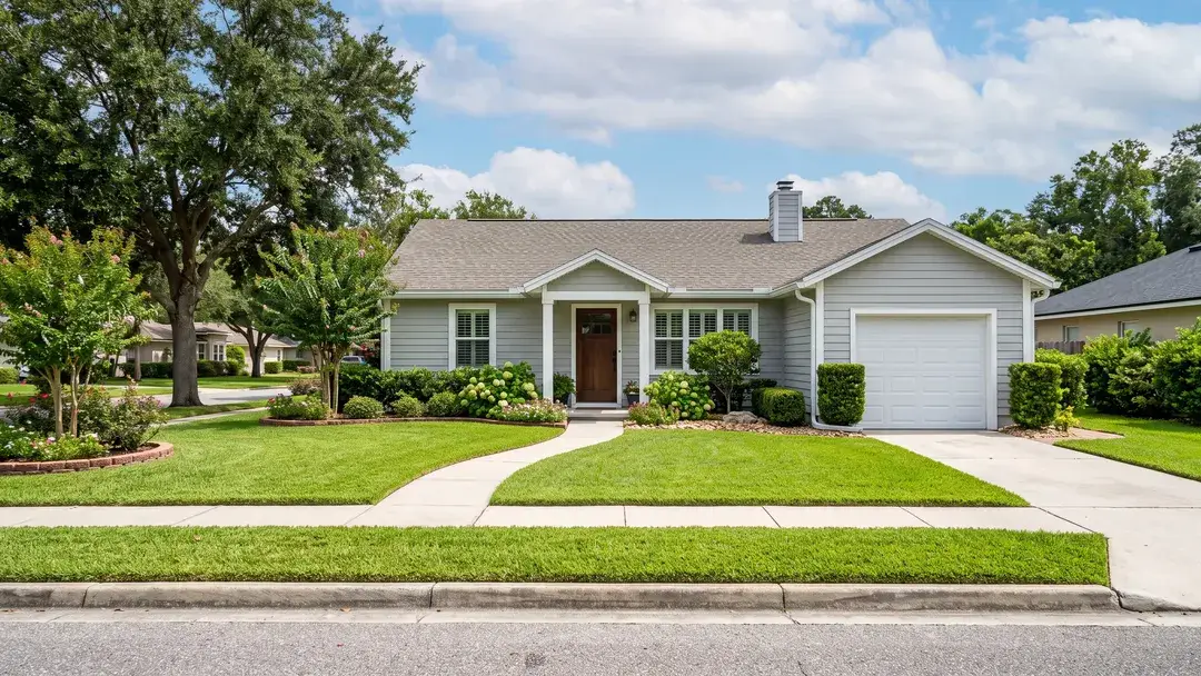 The same house restored, with a green lawn, a clean walkway and driveway